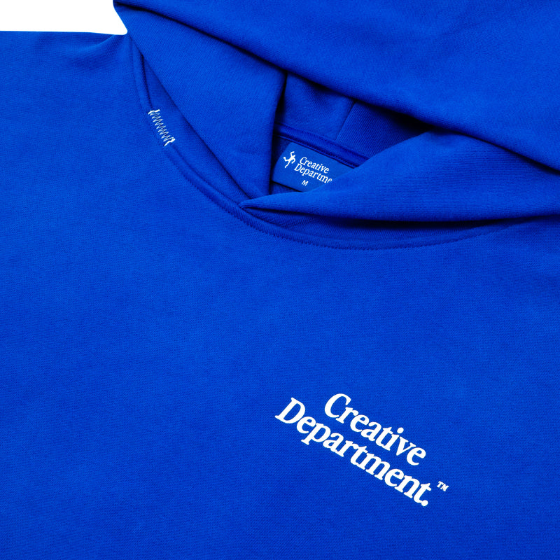 Close detail of the blue hoodie's chest print and fabric